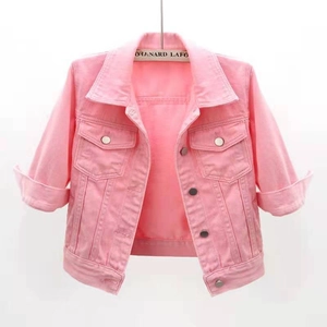 Detail of pink denim jacket featuring buttoned chest pockets and a classic turn-down collar