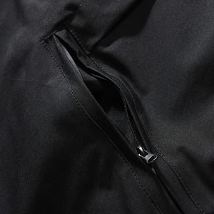 Detailed close-up of premium black nylon fabric with concealed matte metal zipper
