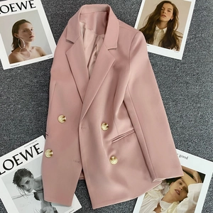 Flat lay detail of pink double-breasted blazer with golden matte buttons and lapels