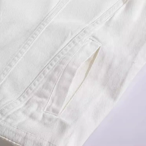 Men's slim fit white denim vest in twill fabric showing detailed side pocket and texture