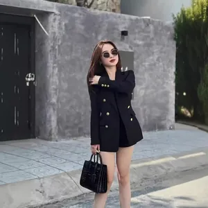 Women's black double-breasted blazer with gold buttons in a stylish loose fit
