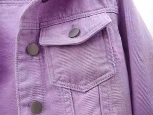 Close-up of purple denim jacket featuring metal buttons and textured cotton twill fabric