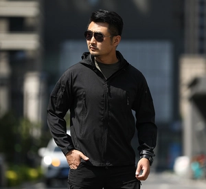 Men's black tactical softshell jacket with hood, multiple zipper pockets and velcro cuffs