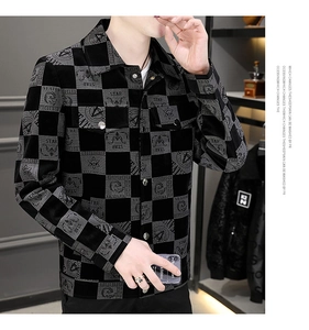 Detail of men's casual checkered jacket featuring star prints and metal button closure