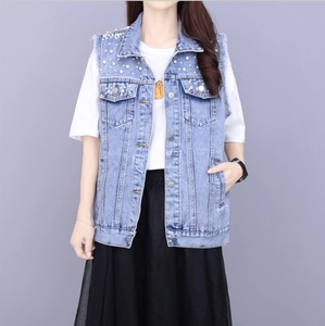 Detailed view of light blue denim vest with beaded pearls and frayed sleeve edges