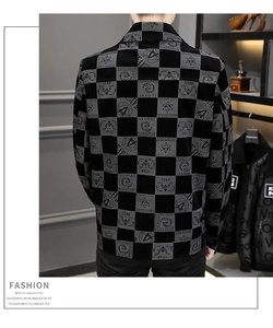 Detail of men's black checkered jacket featuring star patterns and street fashion text