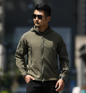 Detail of army green tactical softshell jacket featuring waterproof zippers and hooded design