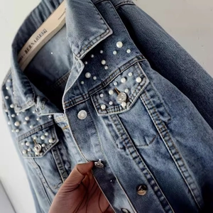 Light blue denim jacket for women featuring white pearl embellishments and metal buttons