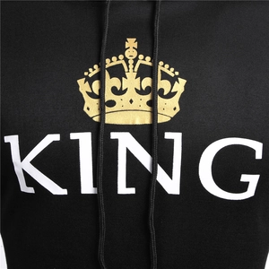 Detail of a black hoodie featuring a golden crown and bold KING text print