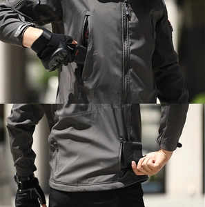 Detail of shark skin softshell jacket showing waterproof chest pocket and rear zip compartment