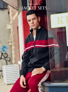 Detail of color-block jacket with stand collar and red track pants for casual sports