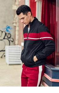 Detail of men's casual tracksuit featuring red and white color blocking on a black jacket