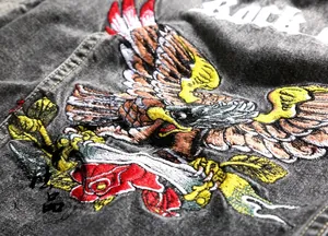 Detailed rock eagle embroidery on premium gray distressed denim vest with sharp stitching