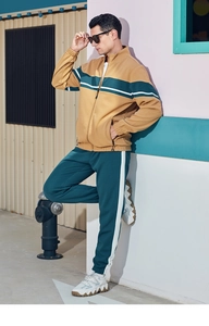 Side view of men's two-tone tracksuit with khaki and green panels and white stripes