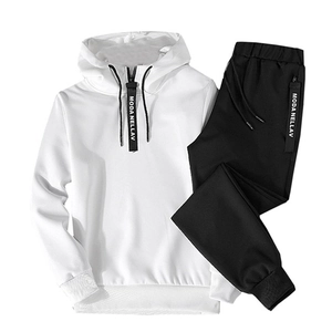 Detail of white half-zip hoodie and black joggers with branded letter tape accents