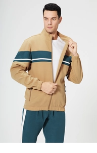 Detail of khaki and dark green zip-up tracksuit jacket with color-block chest stripes