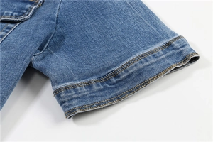 Detail of short sleeves on denim cardigan with contrast stitching and twill fabric