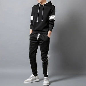 Detail of men's black tracksuit featuring white side tapes with letter branding