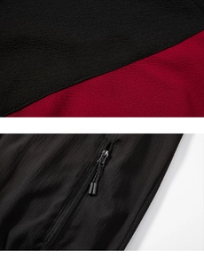 Detail of color-block tracksuit featuring durable textured fabric and functional zipper pocket