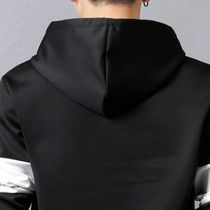 Detail view of the hood and contrast white panel design on the black sporty hoodie