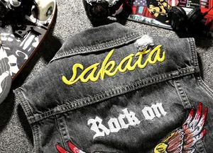 Grey wash denim vest with yellow Sakata embroidery and Rock on print for street fashion