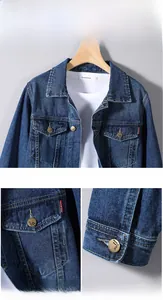 Detailed view of dark blue denim jacket featuring classic flap pockets and metallic buttons