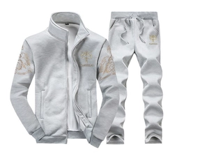 Detail of light gray tracksuit featuring golden logo print and zip-up stand collar