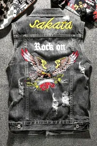 Detail of dark grey distressed denim vest featuring eagle and rose embroidery on back