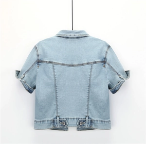 Detail view of the light blue denim crop top back featuring adjustable waist buttons