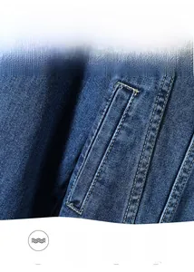 Close-up detail of blue denim jacket showing premium twill texture and yellow double-stitching
