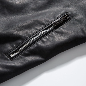 Detailed macro view of black faux leather texture with a durable silver metal zipper