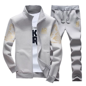 Men's grey slim fit tracksuit featuring zipper jacket with gold logo and matching joggers