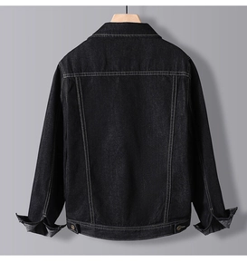 Detail view of black denim jacket with white contrast stitching and back adjustable buckles
