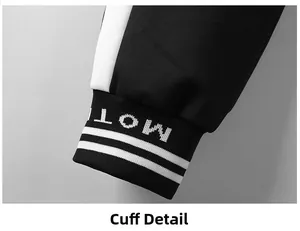 Gros plan du poignet du pantalon de sport noir avec rayure blanche et motif MOTI