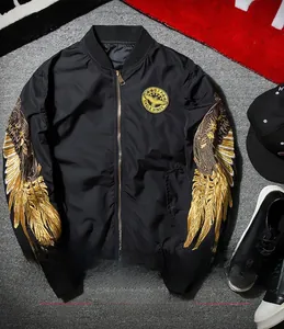 Close-up of golden wing embroidery on a black MA-1 bomber jacket sleeve detail
