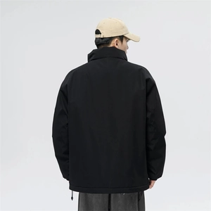 Detail view of adjustable drawstring hem on a black minimalist high street windbreaker jacket