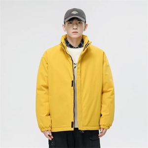 Detail view of bright yellow high street stand collar jacket with black zipper and windproof fabric