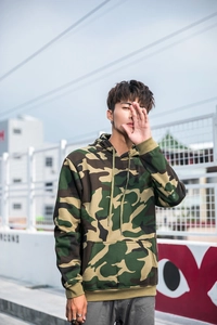 Detail of street fashion camo hoodie with kangaroo pocket and drawstring hood