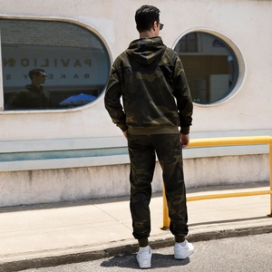 Back view of men's camouflage hooded tracksuit set with cuffed pants in jungle green