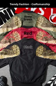 Detailed close-up of intricate gold wing embroidery on a satin bomber jacket