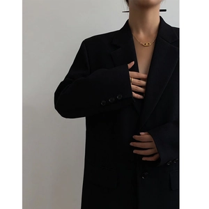 Classic gold double-ring necklace with minimalist ring on model in black suit