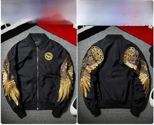 Close-up of golden eagle wings embroidery on black waterproof MA-1 flight bomber jacket