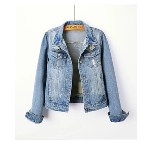Detailed view of light blue denim jacket with vintage metal buttons and distressed texture