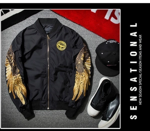 Detail of golden eagle wing embroidery on sleeves of a black MA-1 bomber jacket