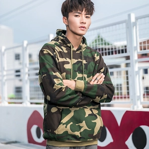 Detail shot of the forest camouflage hoodie fabric and kangaroo pocket in a street setting