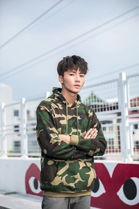 Detail of urban camouflage hoodie with adjustable drawstring and kangaroo pocket features