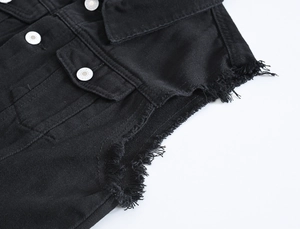 Men's black denim vest with frayed edges and metal buttons in a street style look