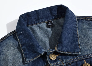 Detailed macro view of denim jacket collar with size label and fashion metallic button