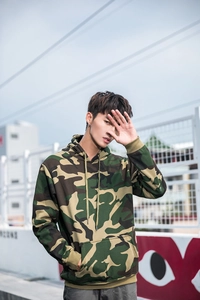 Detail of camouflage drawstring hoodie with front kangaroo pocket and ribbed cuffs
