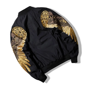 Black MA-1 bomber jacket featuring intricate gold wing embroidery on back and sleeves